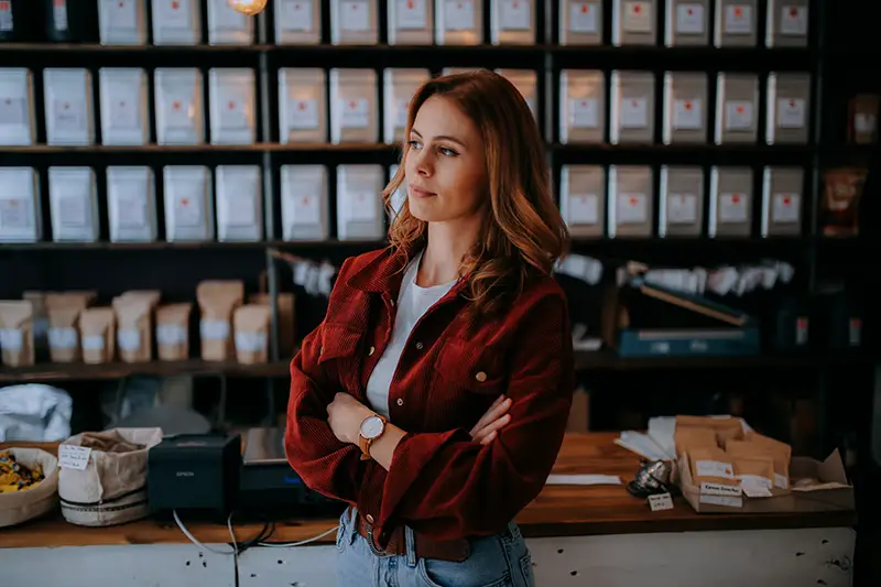 Woman standing wearing brown jacket