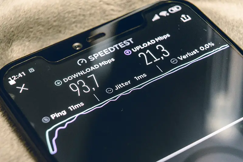 Black smartphone running an internet speed test