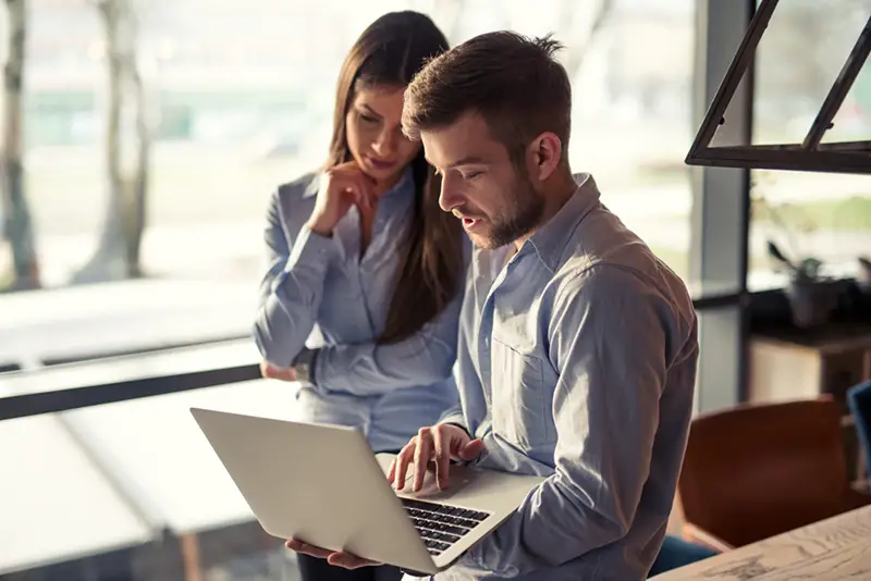 Man and woman working on their laptop