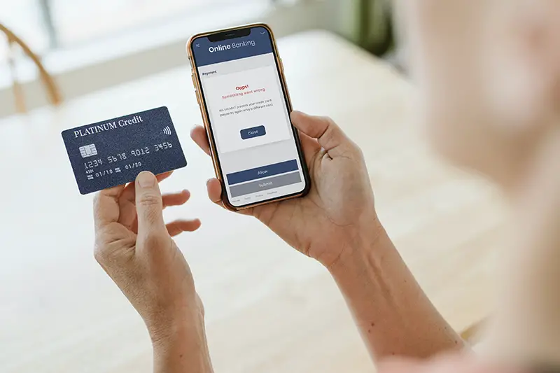 Woman processing her credit card via a mobile phone