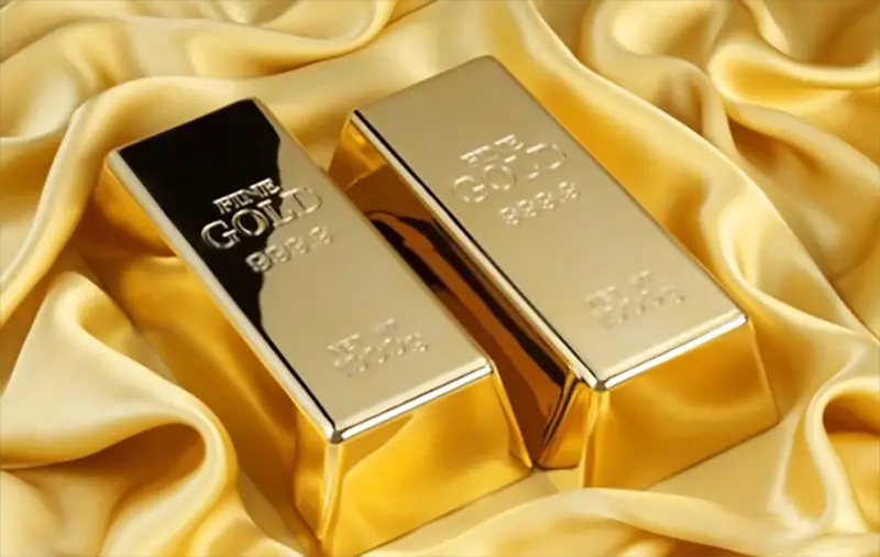 two gold bullion bars on yellow silk