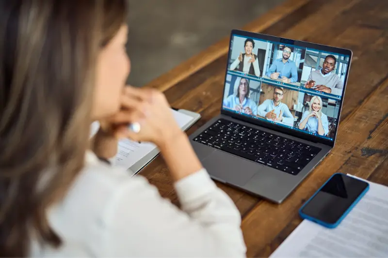 Business woman female team leader manager executive having hybrid office business group meeting, remote workers discussing work plans by video digital conference call on laptop.
