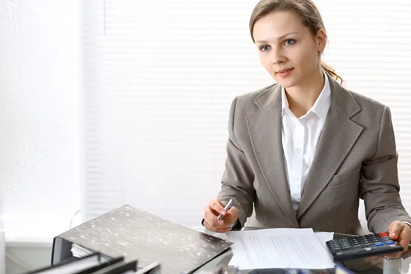 Female accountant wearing brown coat