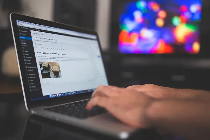 Person typing on silver laptop