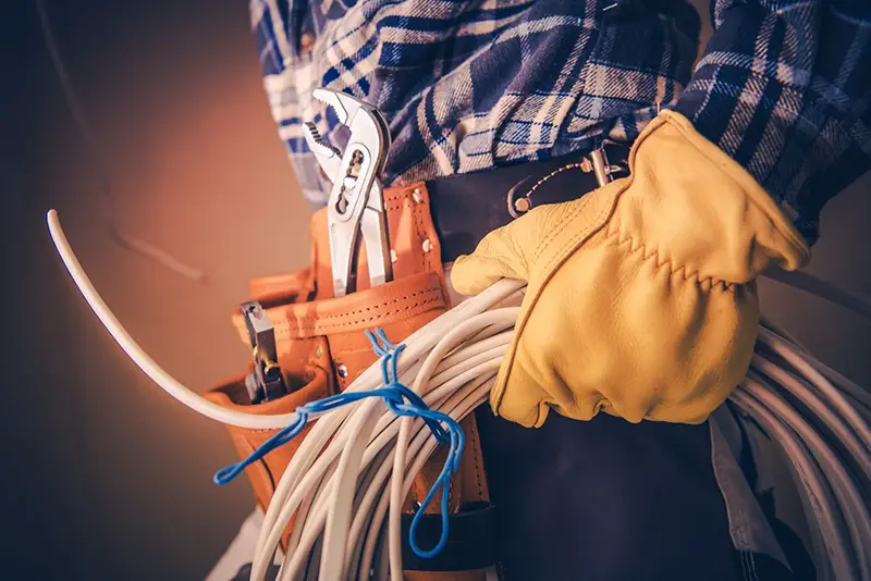 Electrical man holding wire cable