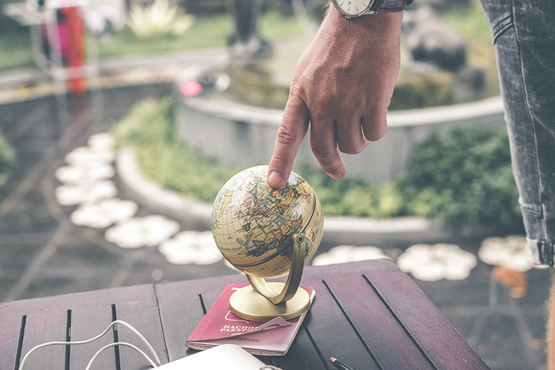 Person holding terrestrial globe scale