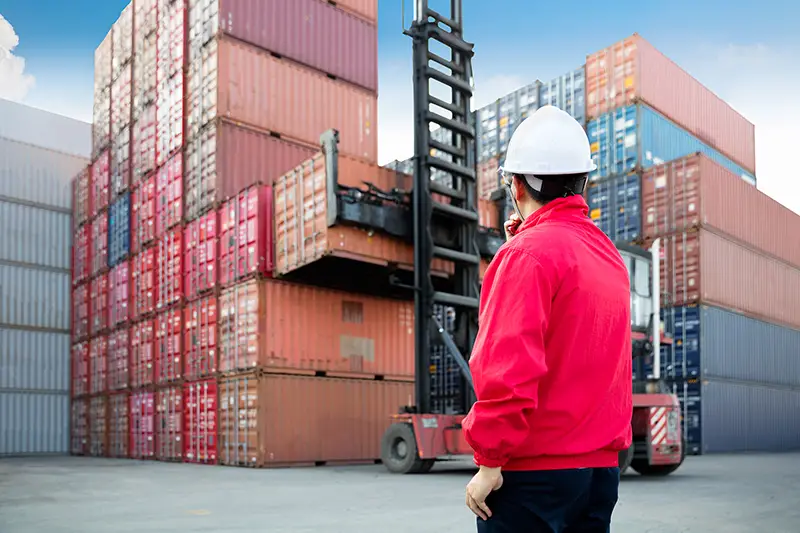 Man wearing red jacket and with hard hat