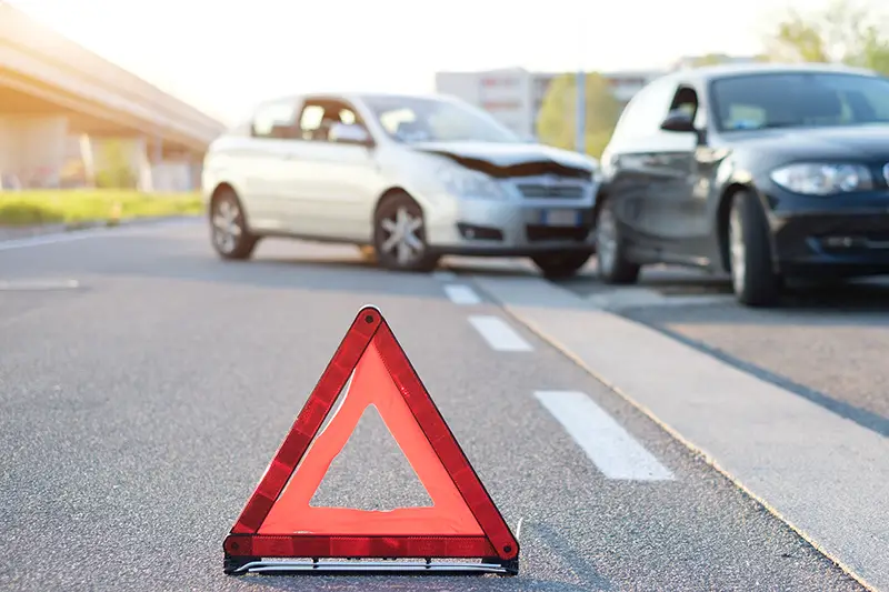 Triangle warning safety sign on the road