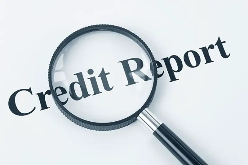 Credit report text and magnifrying glass