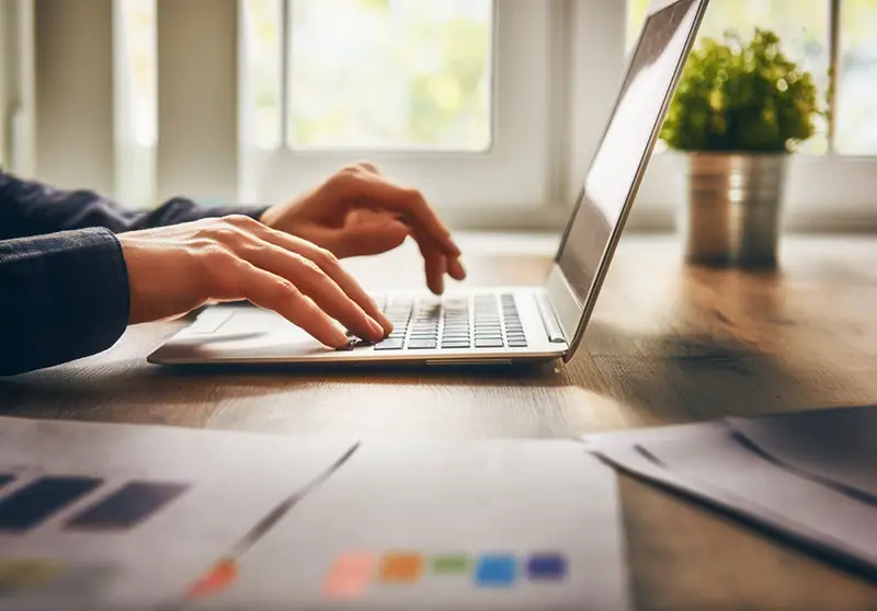 businessman using laptop computer sitting working on logo design