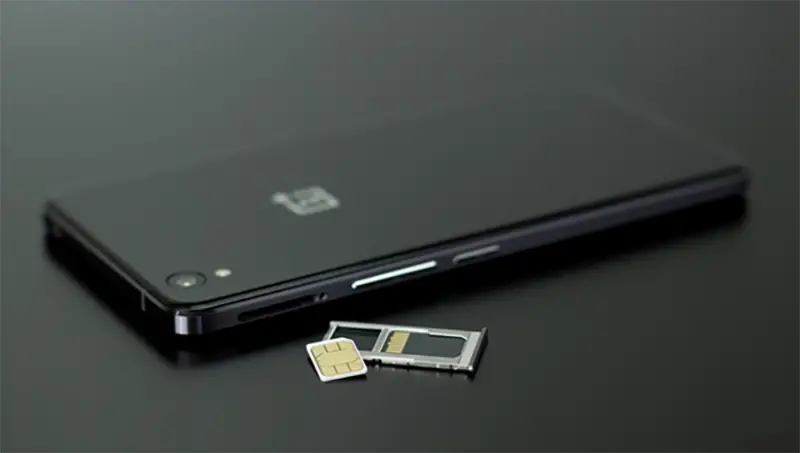 sim card next to black smartphone