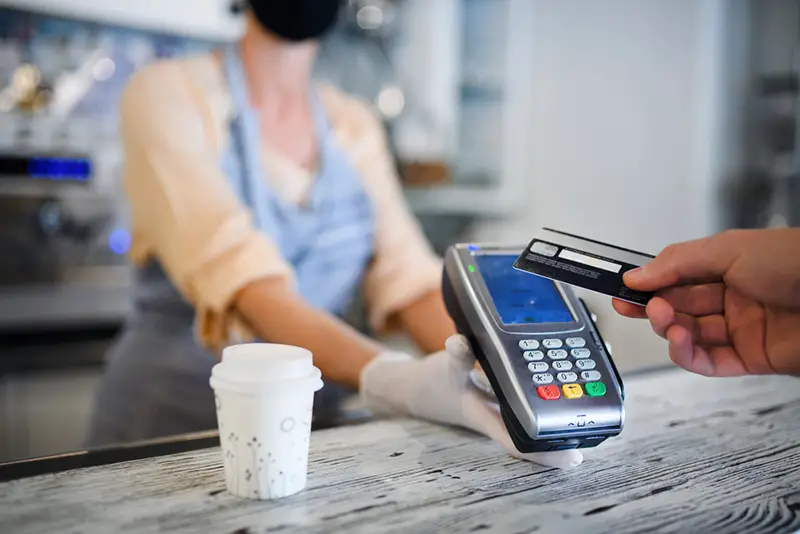 Contactless credit card transaction, coffee shop open after lockdown.