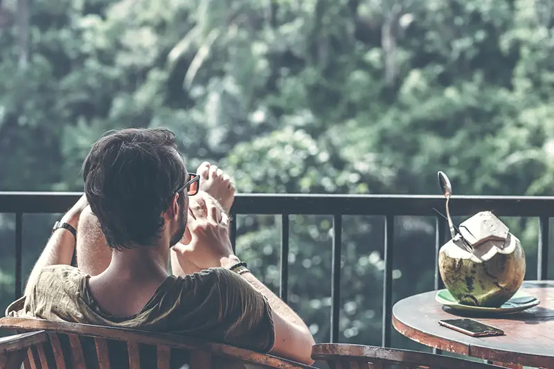 Man sitting on armchair near table