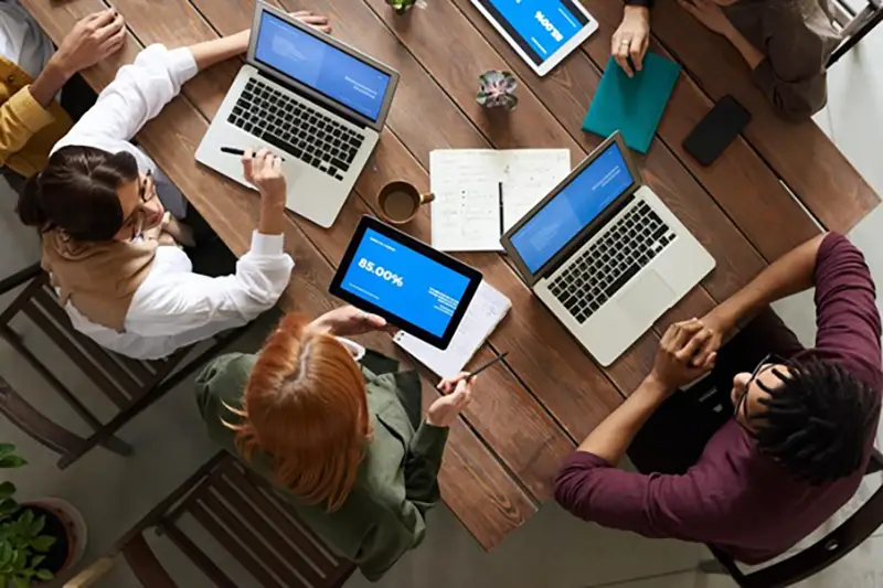 Employees sitting around a table working