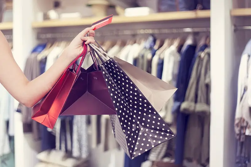 Person carrying paper bags