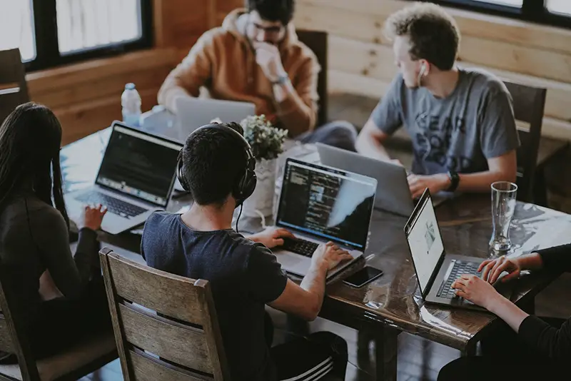 Group of people using laptop