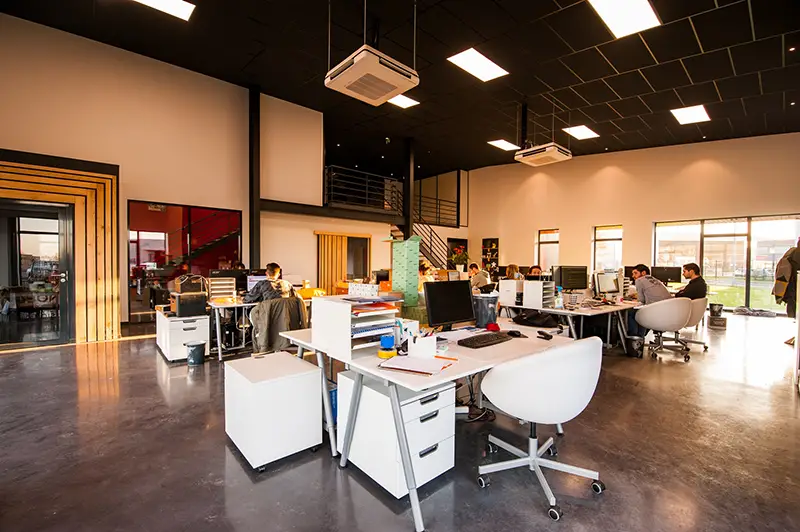 People sittingon chairs next to their desks in an office