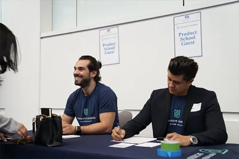 Brand ambassasors sitting at a table welcoming customers