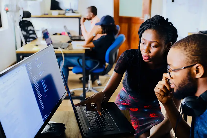 Man and woman sitting in front of the monitor