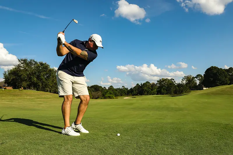 Man in black shirt playing golf