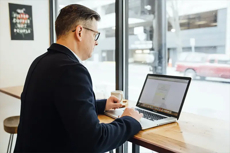 business man working on a laptop in a cafe