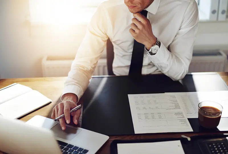 Business man working at office with laptop and documents on his desk, consultant lawyer concept