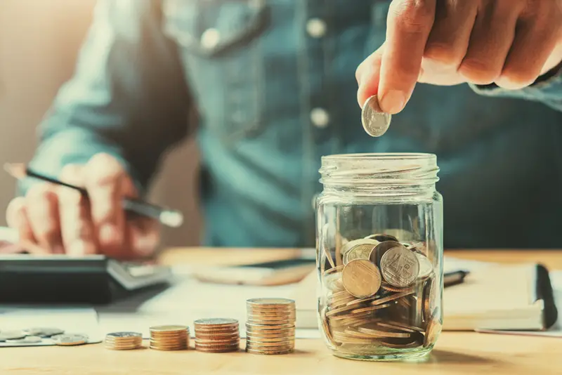 businessman holding coins putting in glass. concept saving money for finance accounting