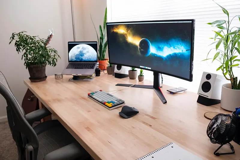 Black flat screen computer monitor in brown wooden desk