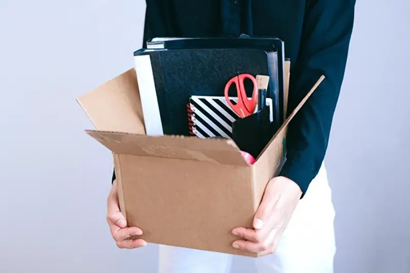 Person carrying box with office stuff
