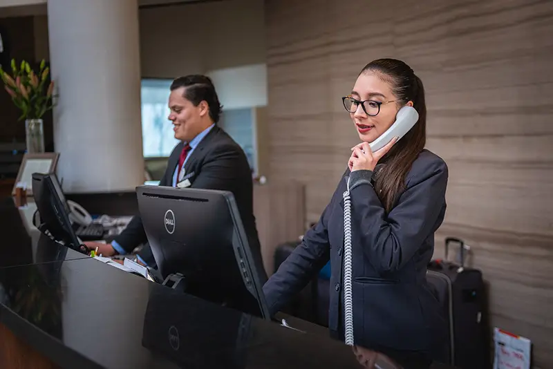 Man and woman receptionist in a hotel