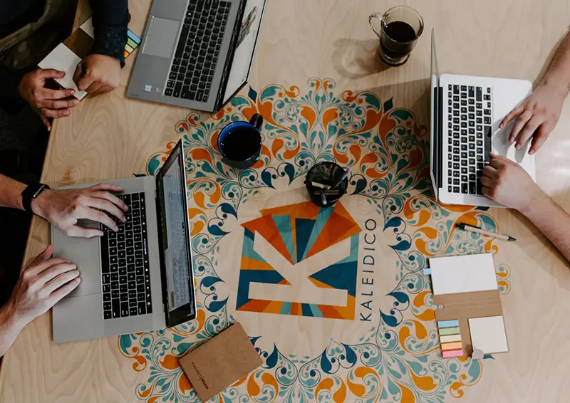 Three persons using laptop