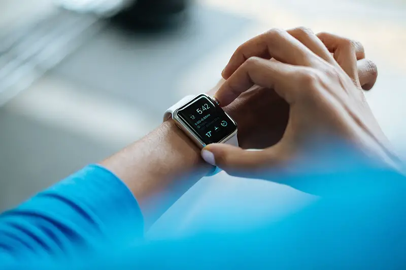 Man wearing blue longsleeve and black smartwatch