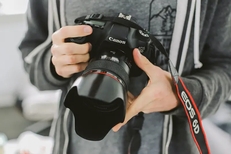 Person holding Canon camera