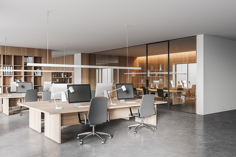 Corner of modern open space office with white and wooden walls, concrete floor and rows of computer tables. Meeting room in the background. 3d rendering