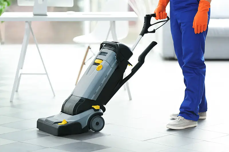 Man using vacuum for floor cleaning