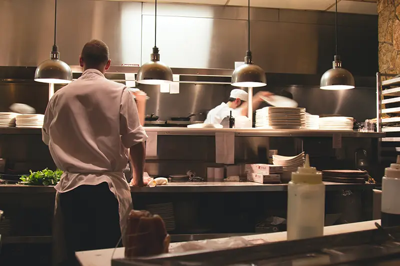 Man wearing white long sleeves working in the kitchen