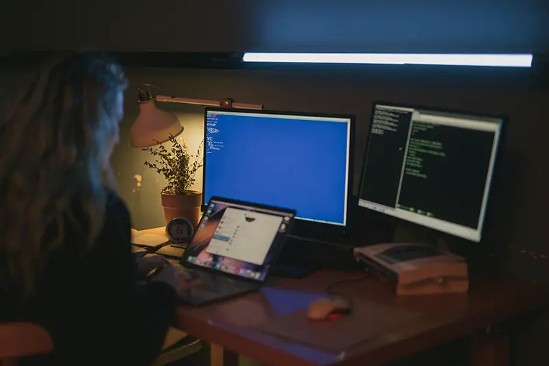 Woman using computer in a dim light