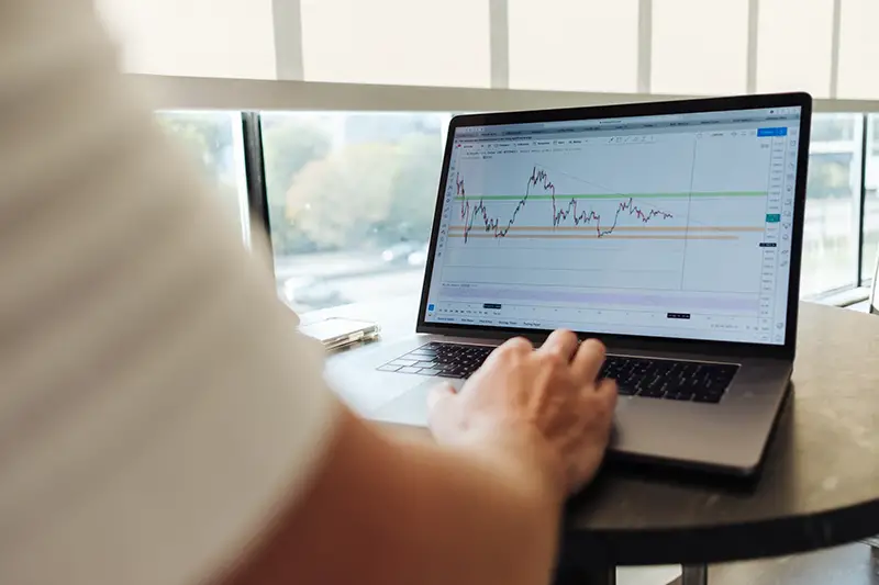 Person using macbook pro on the table