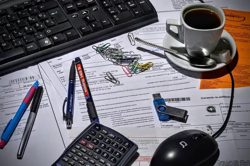 bookkeeper accountant - coffee cup on top of paperwork