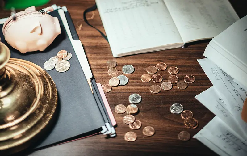 Desk covered in coins