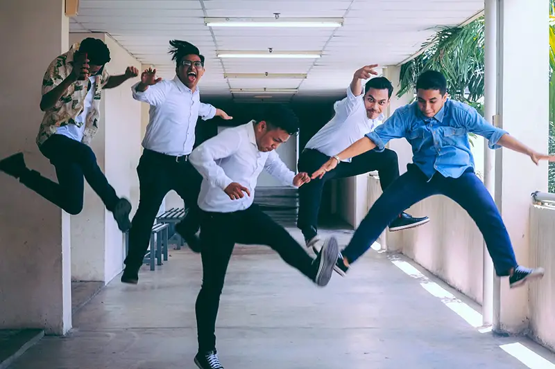 group of employees jumping and captured by shot of them in mid air
