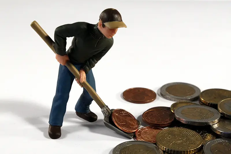 Male figure toy digging money coins