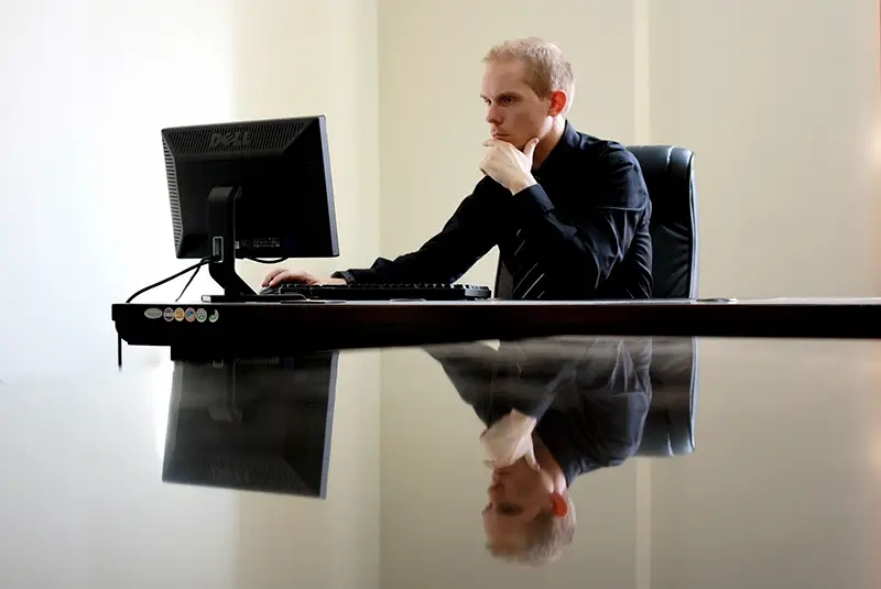 Businessman sitting on his black leather chair