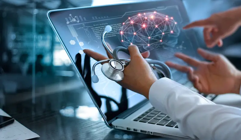 Diagnose checking brain testing result with modern virtual screen interface on laptop with stethoscope in hand
