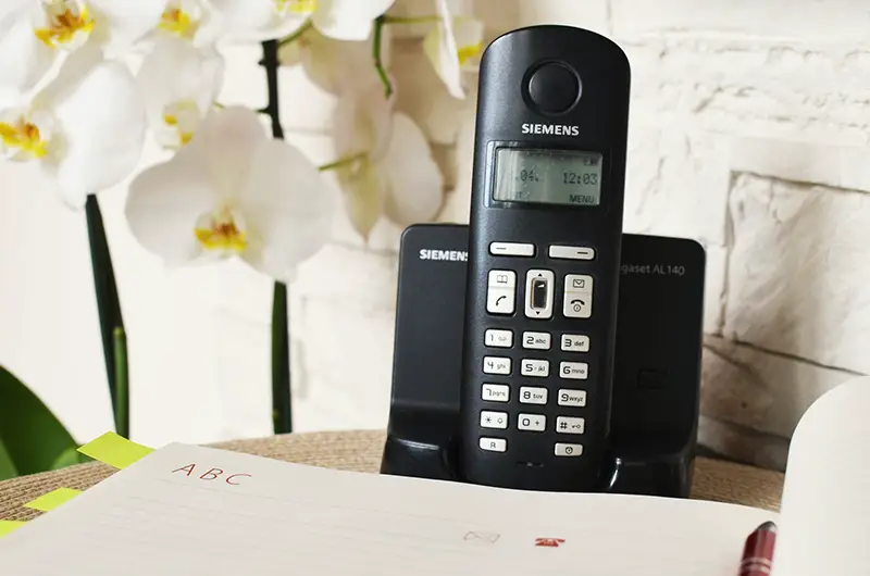 black siemens telephone in charging cradle