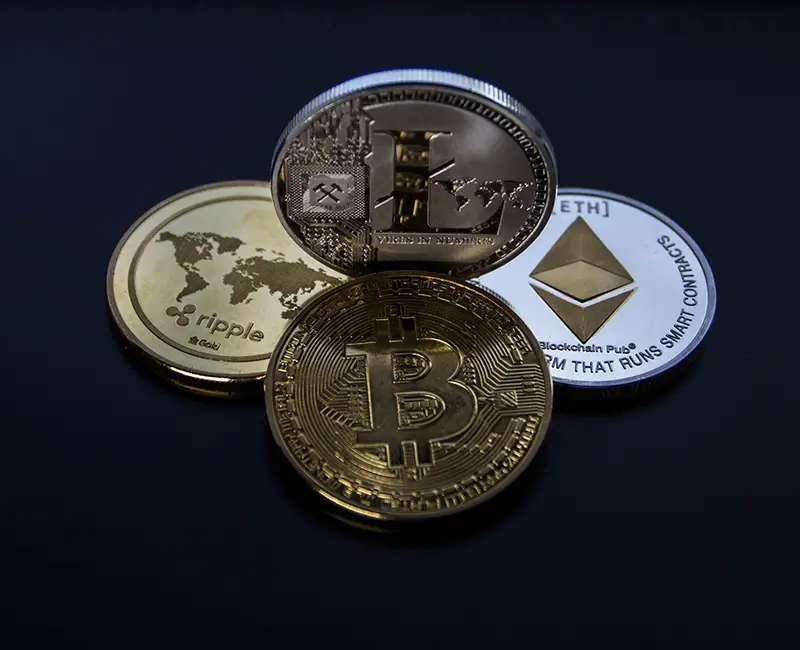 four assorted popular cryptocurrency coins