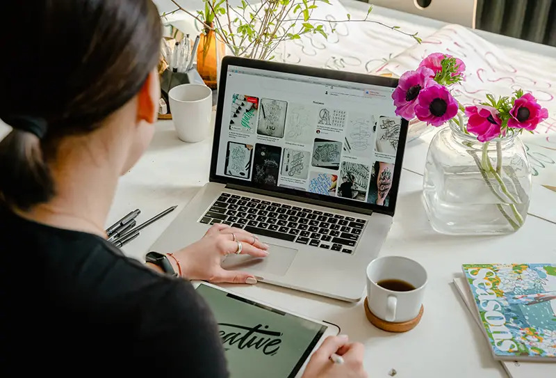 Woman graphic designer working on her laptop