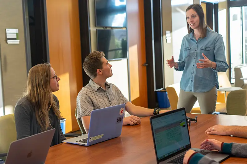 Woman standing talking in a meeting