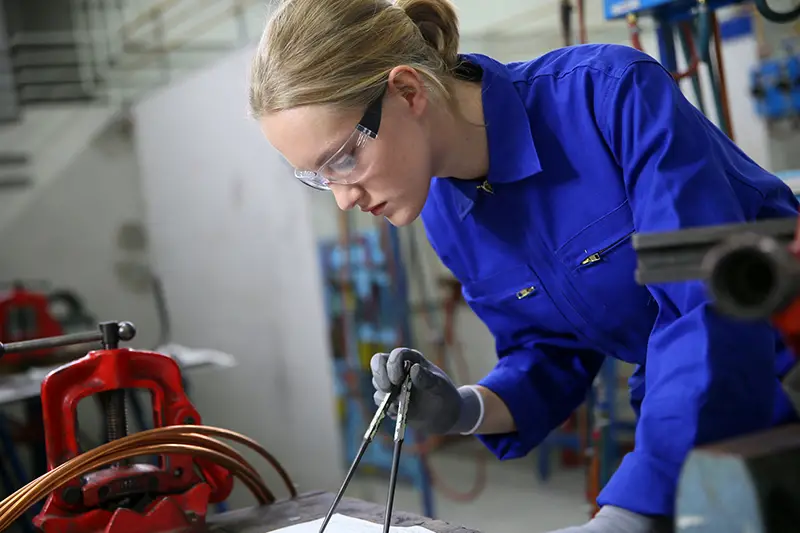 Young woman apprentice in plumbery