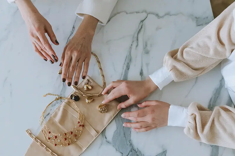 Hand of a woman touching jewelry accessories